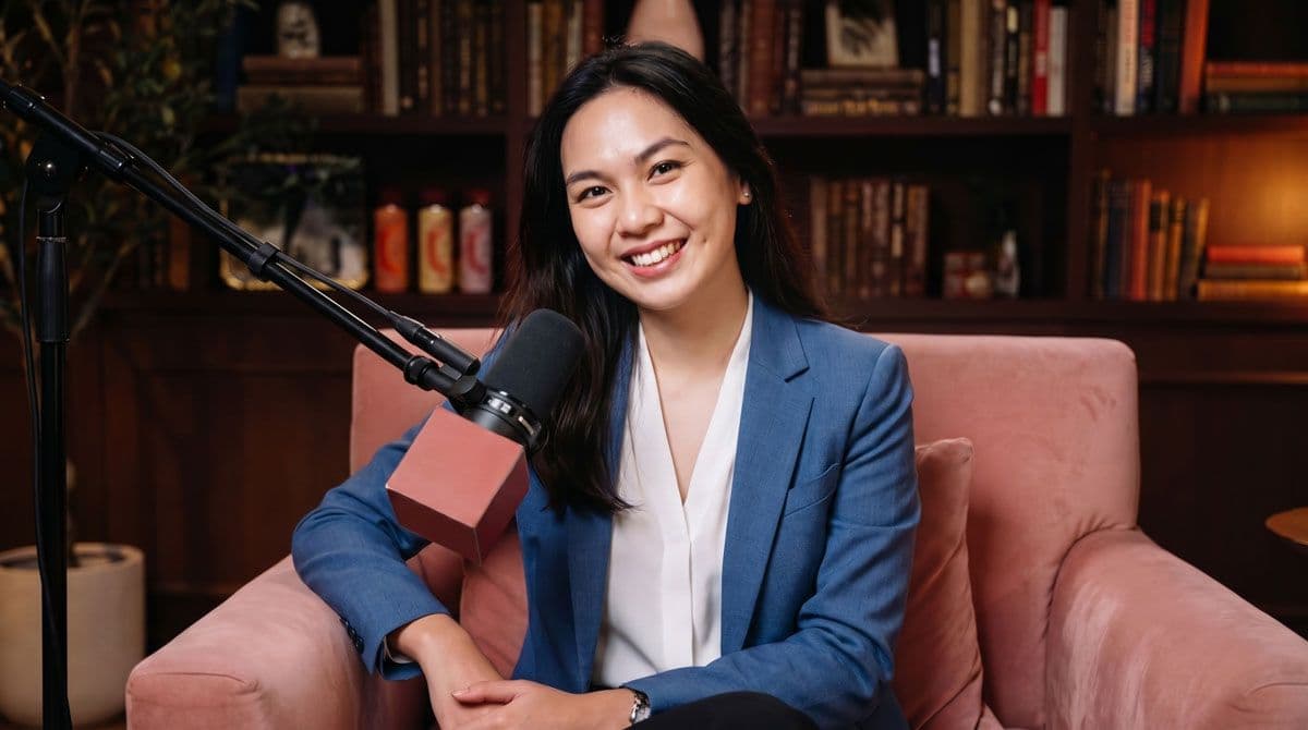 Bu Elika smiling from an armchair during her interview