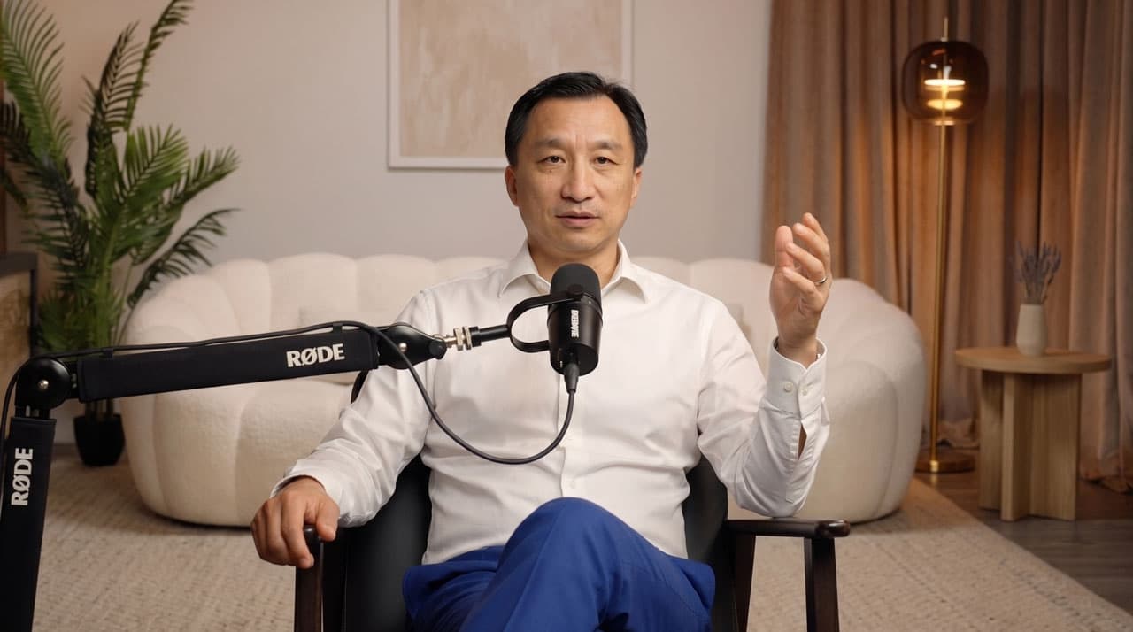 Pak Widianto mid-conversation behind a studio microphone
