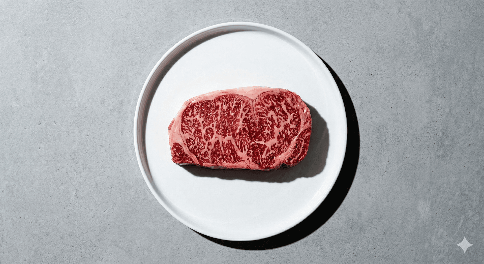 A perfectly marbled wagyu steak on a white plate